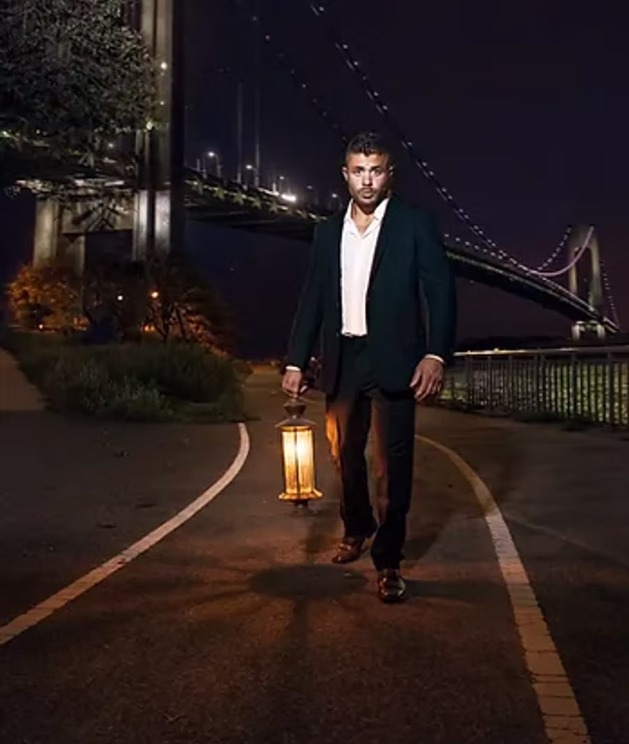 Jeffrey Wachman walking at night with a lantern