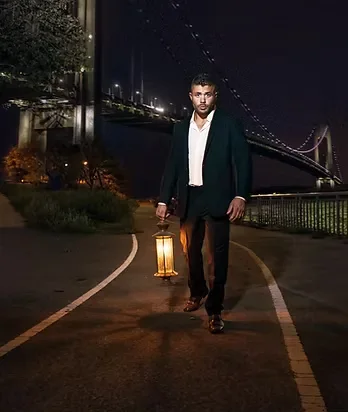 Jeffrey Wachman beside a bridge at night